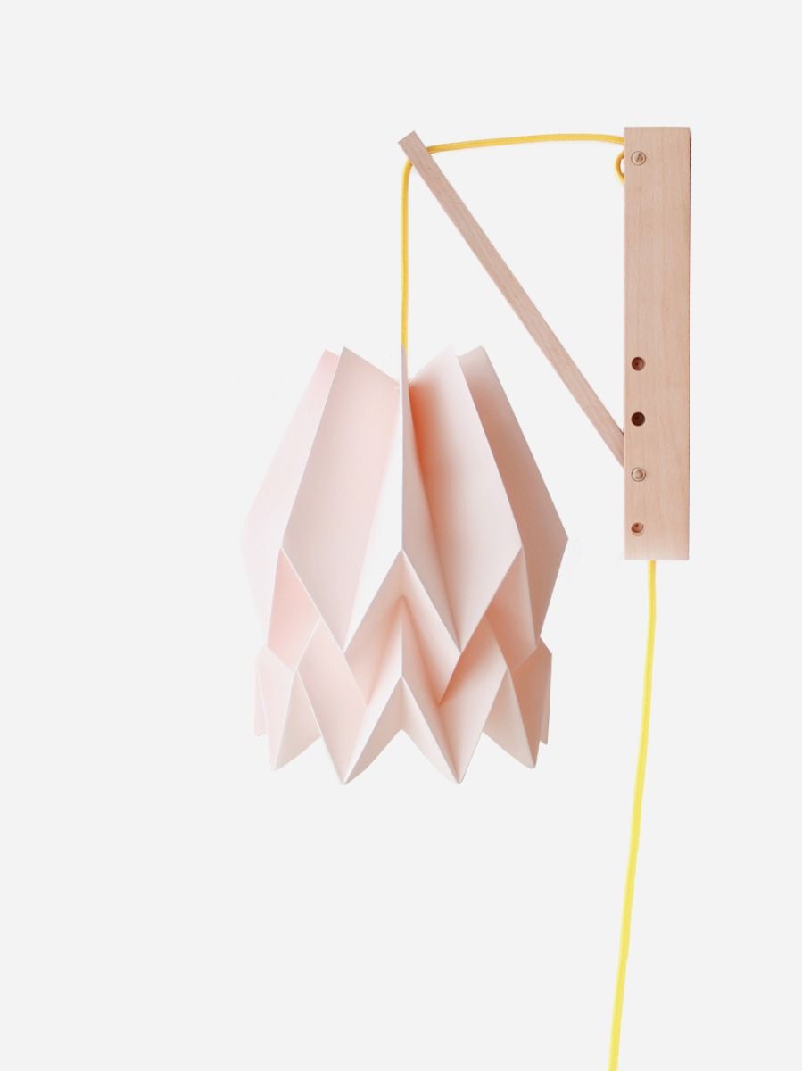 Pink hand-crafted origami wall lamp with wooden structure and textile cable. 