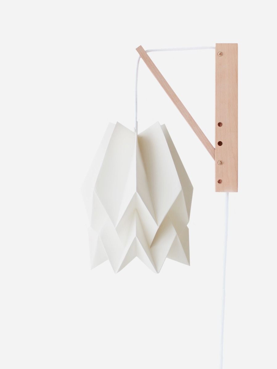 White hand-crafted origami wall lamp with wooden structure and textile cable. 