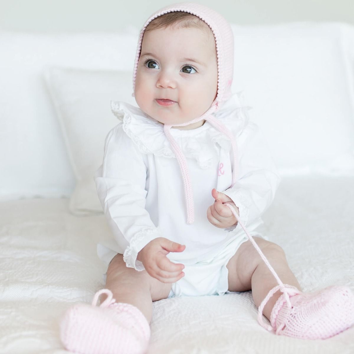 The hands of our artisans bring to life the softest organic cotton yarn and with the most beautiful valenciennes lace create a genuine masterpiece that becomes part of the family’s heirlooms. Our Purity Baby Blouse will keep your baby warm, cozy and elega