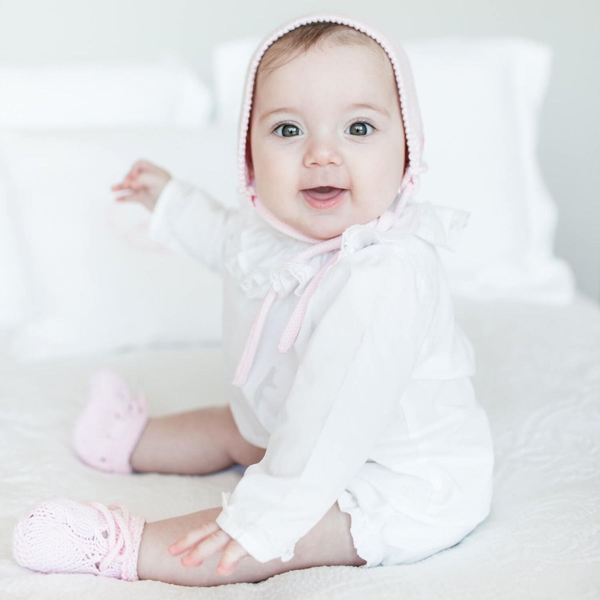 The hands of our artisans bring to life the softest organic cotton yarn and with the most beautiful valenciennes lace create a genuine masterpiece that becomes part of the family’s heirlooms. Our Purity Baby Blouse will keep your baby warm, cozy and elega