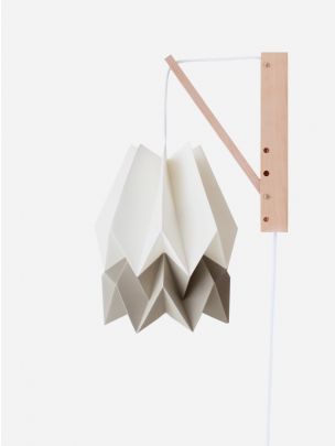 Hand-crafted origami wall lamp with wooden structure and textile cable.